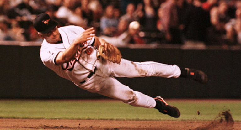 Cal Ripken Jr., of the Baltimore Orioles makes a diving throw to first base.