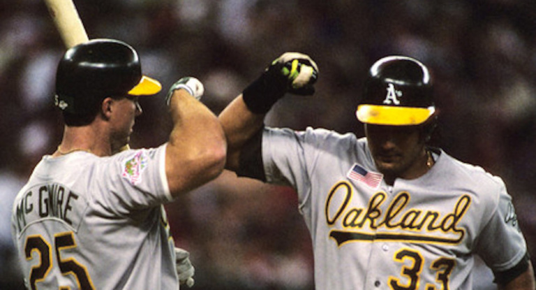 Jose Canseco of the Oakland Athletics is congratulated by Mark McGwire