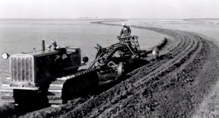 farmer plows a field during the dust bowl
