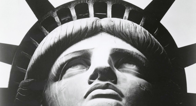 Black and white close-up of the face of the Statue of Liberty.