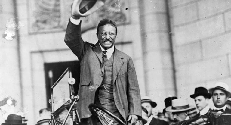 Theodore Roosevelt waves to the crowd.