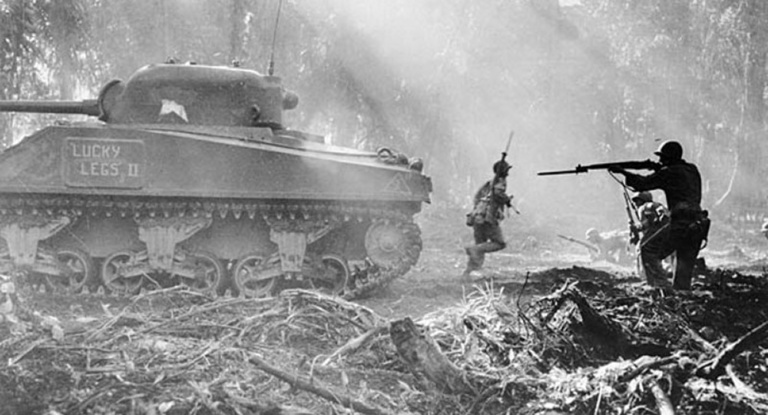 Covered by a tank, American infantrymen secure an area on Bougainville in the Solomon Islands