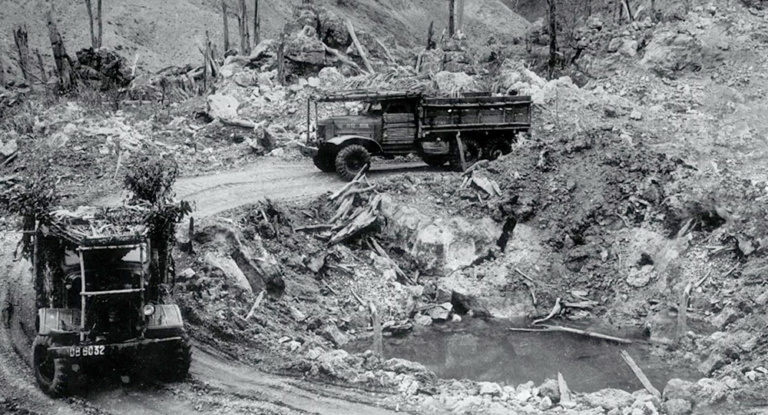 Vietnamese trucks drive along reconstructed roads on the Ho Chi Minh trail.
