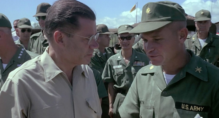 Defense Secretary Robert McNamara speaks with a US soldier.